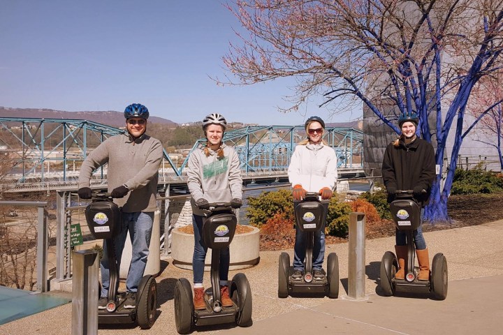 a group of people riding on the back of a motorcycle