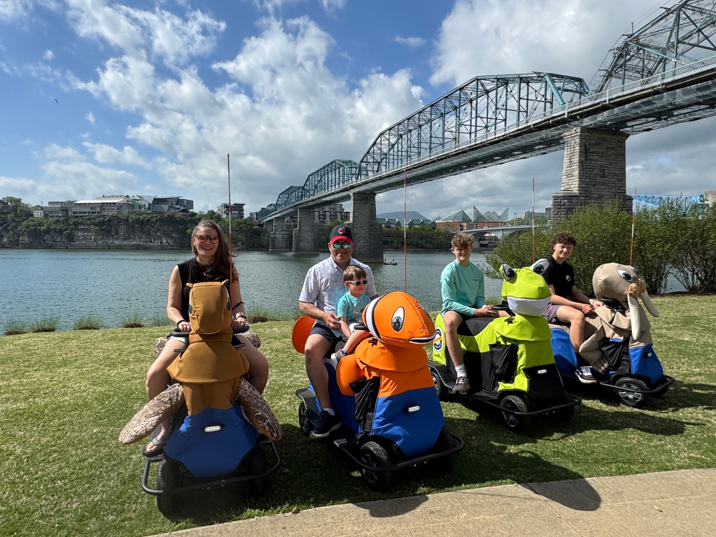a group of people sitting in the grass