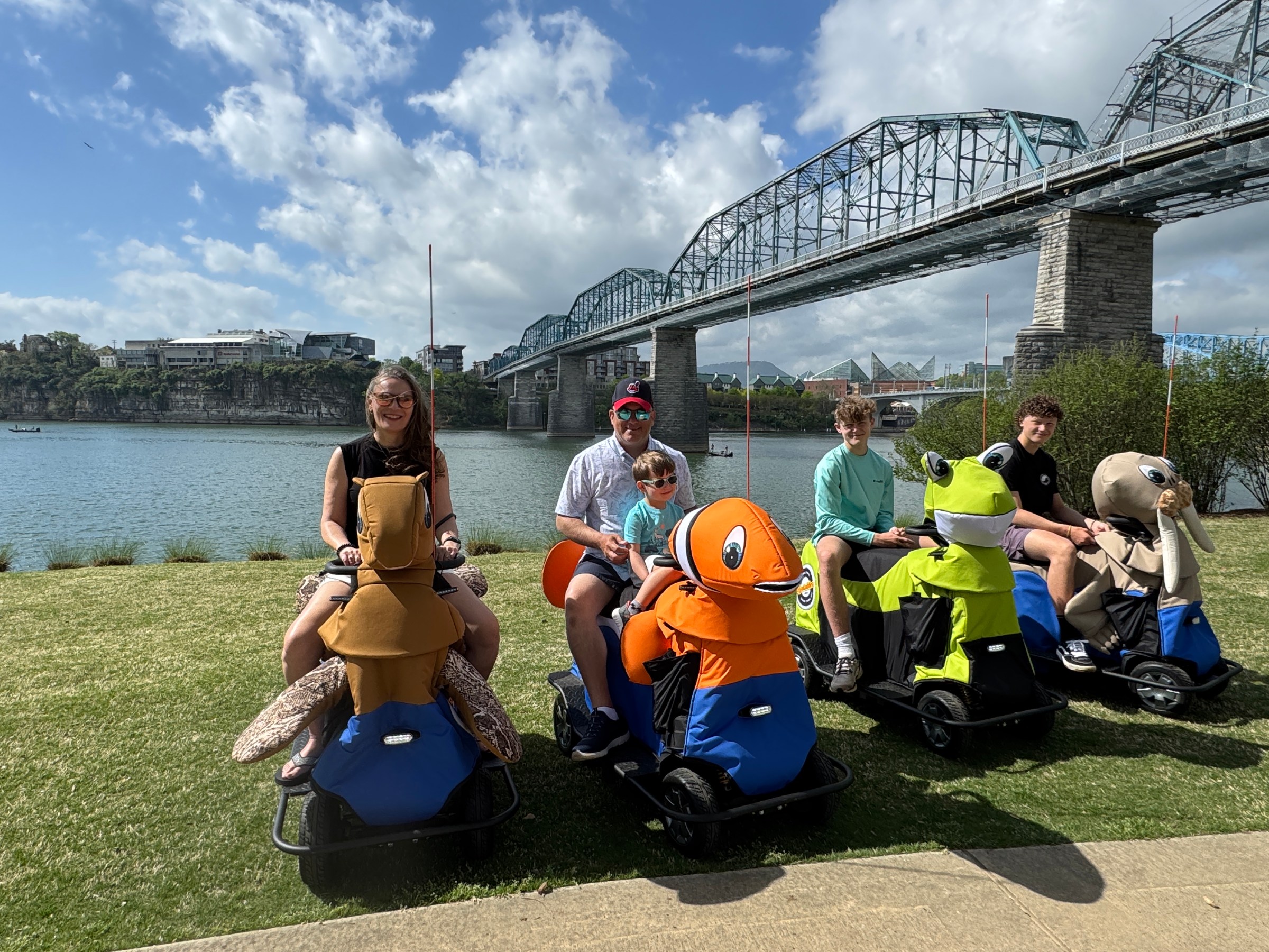 a group of people sitting in the grass