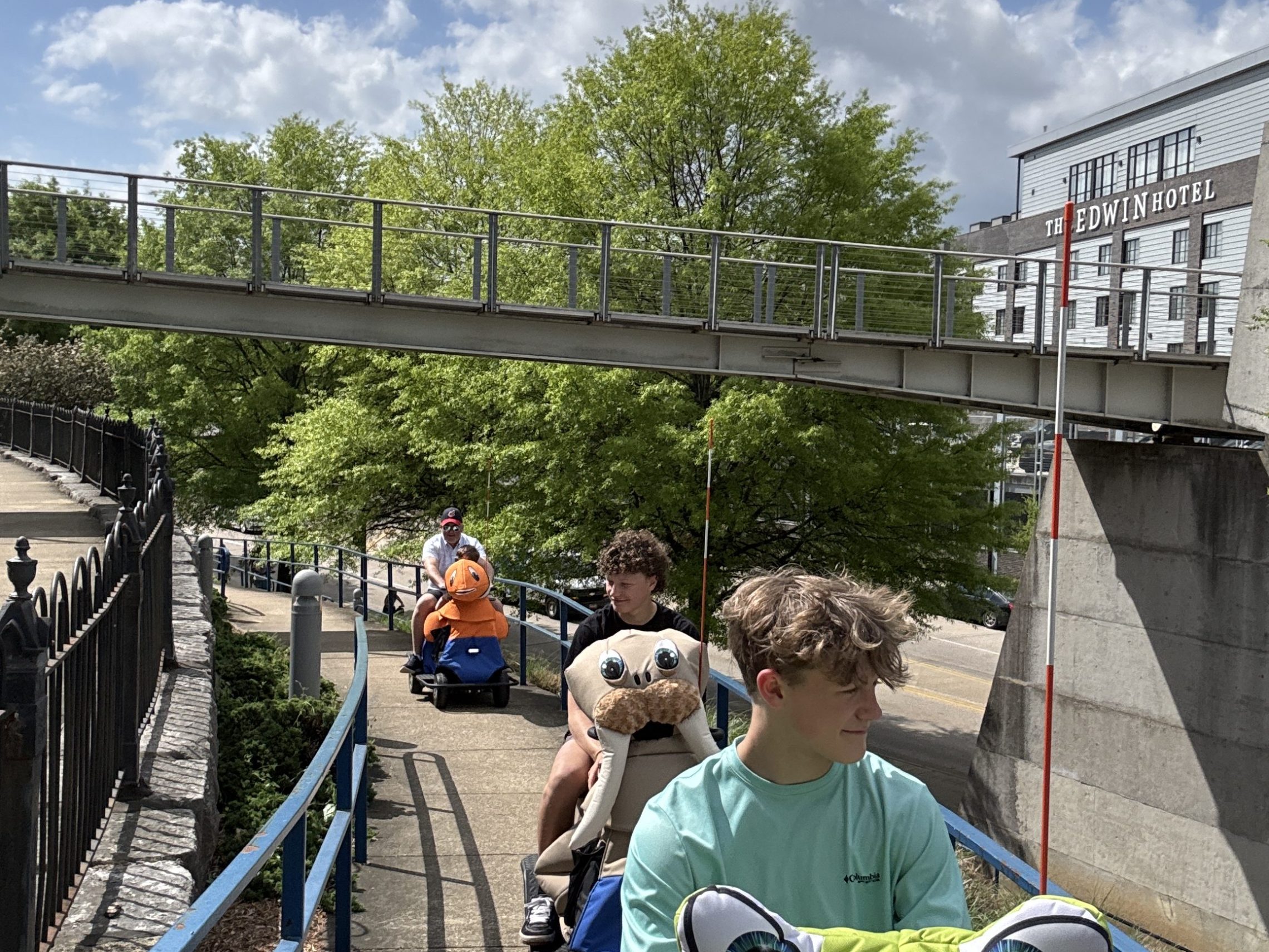 a group of people walking on a bridge