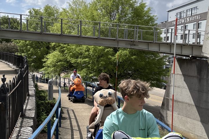 a group of people walking on a bridge