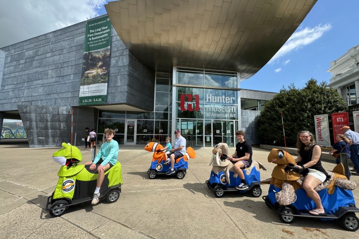 a group of people sitting in a parking lot