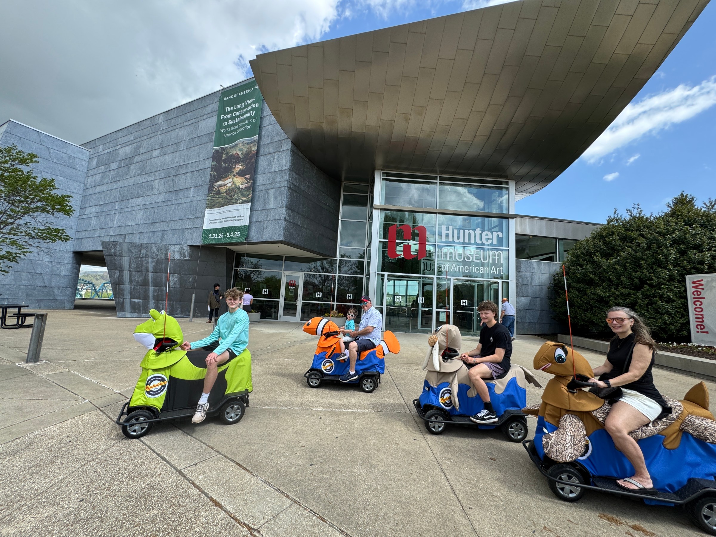 a group of people sitting in a parking lot