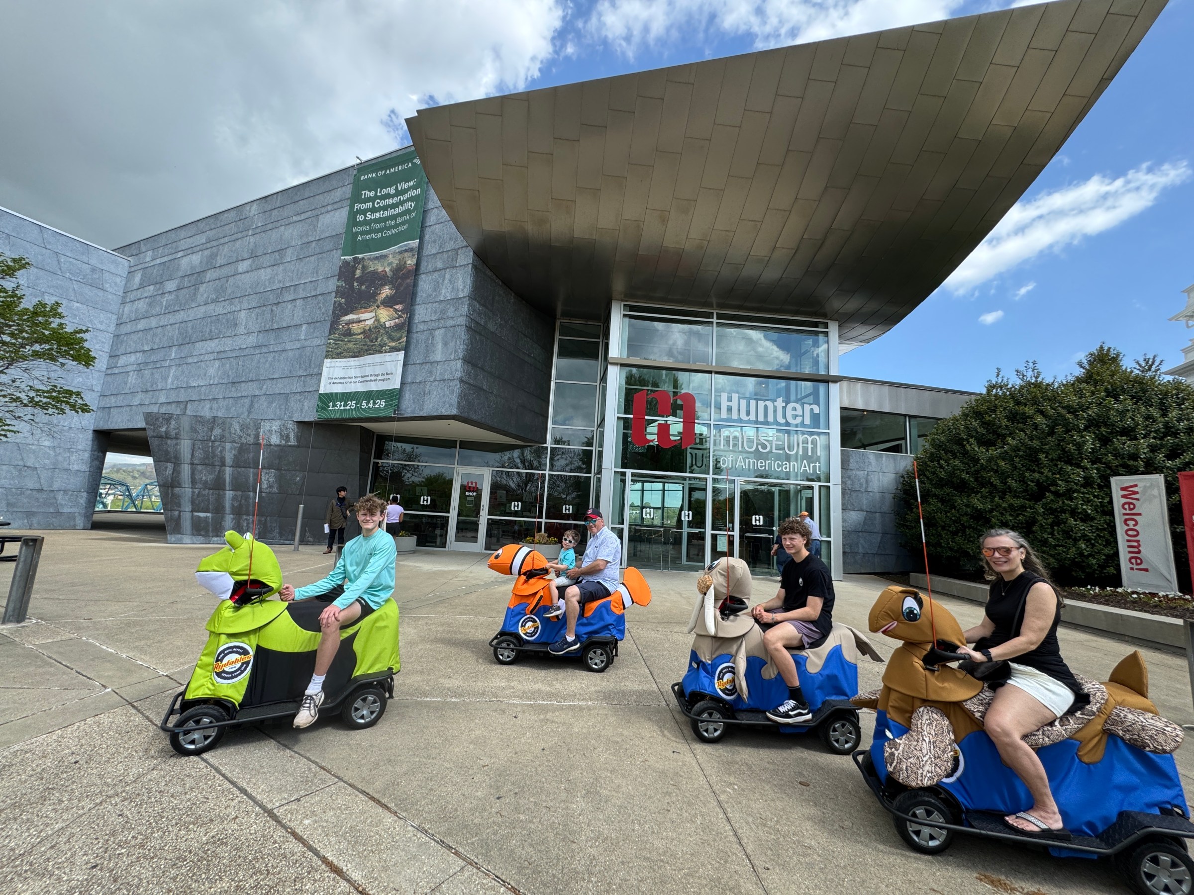 a group of people sitting in a parking lot