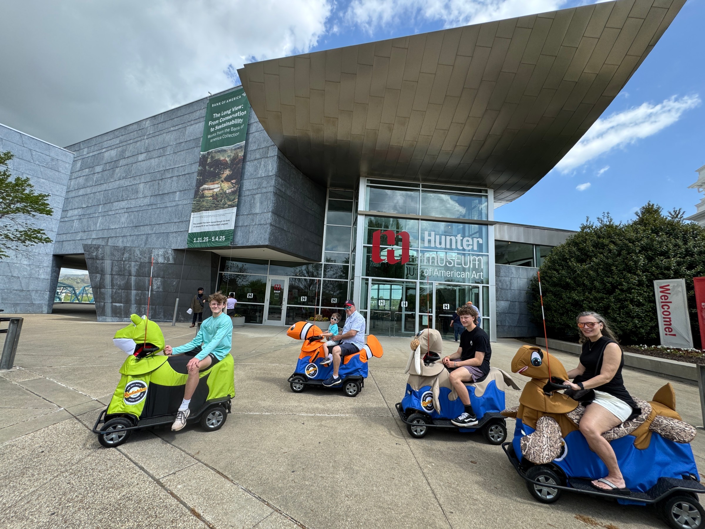 a group of people sitting in a parking lot