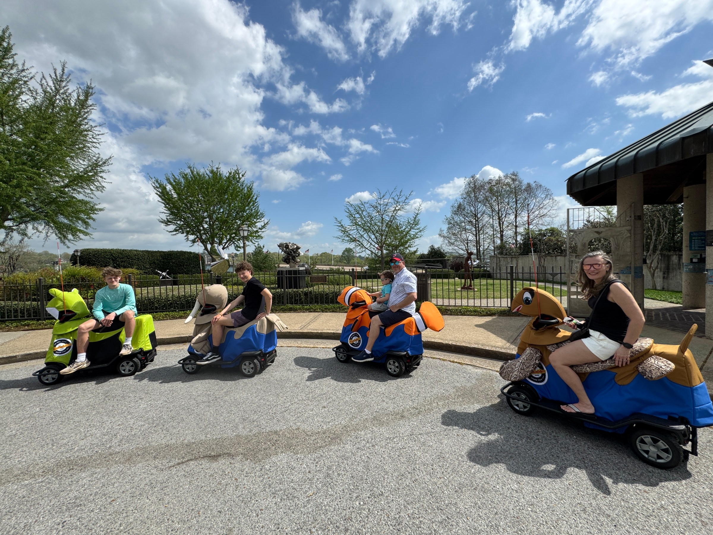 a group of people sitting in a parking lot