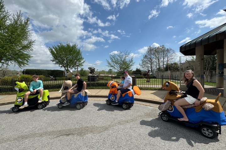 a group of people sitting in a parking lot