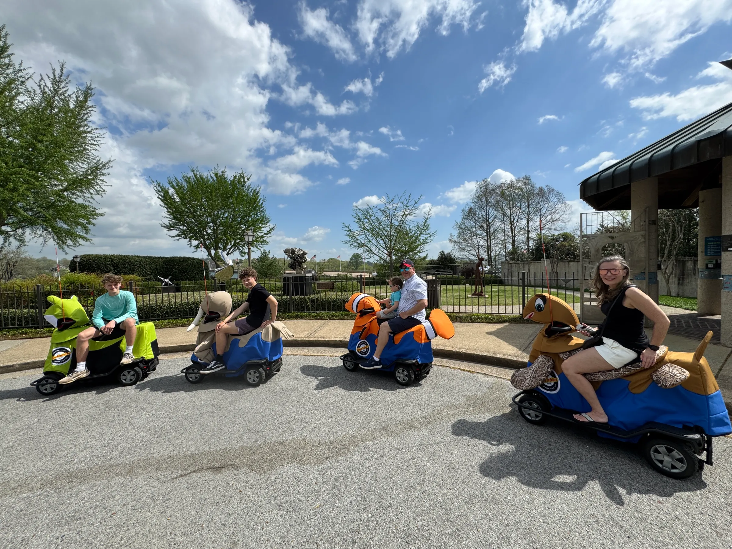 a group of people sitting in a parking lot