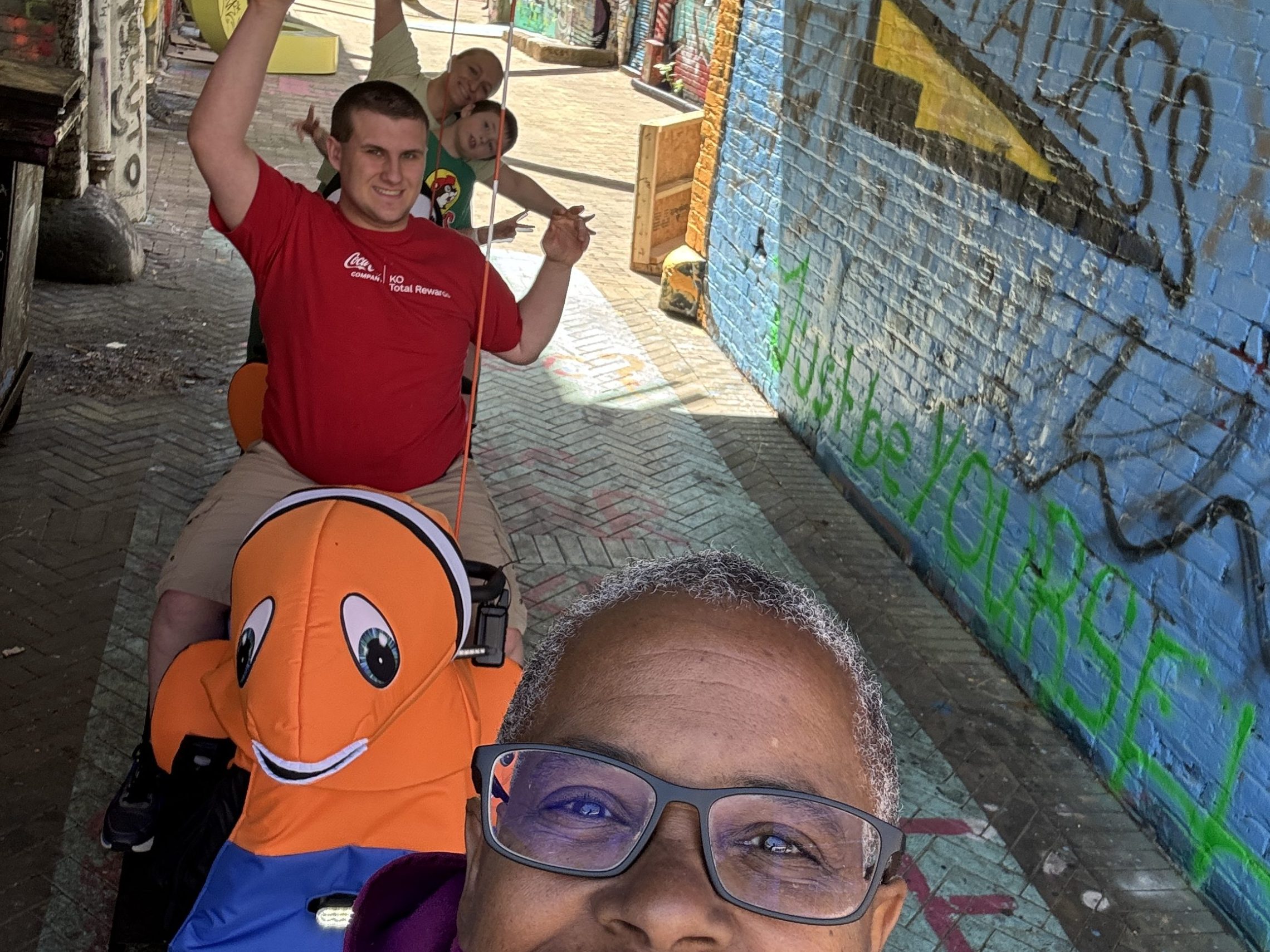 a man wearing sunglasses and standing in front of a building