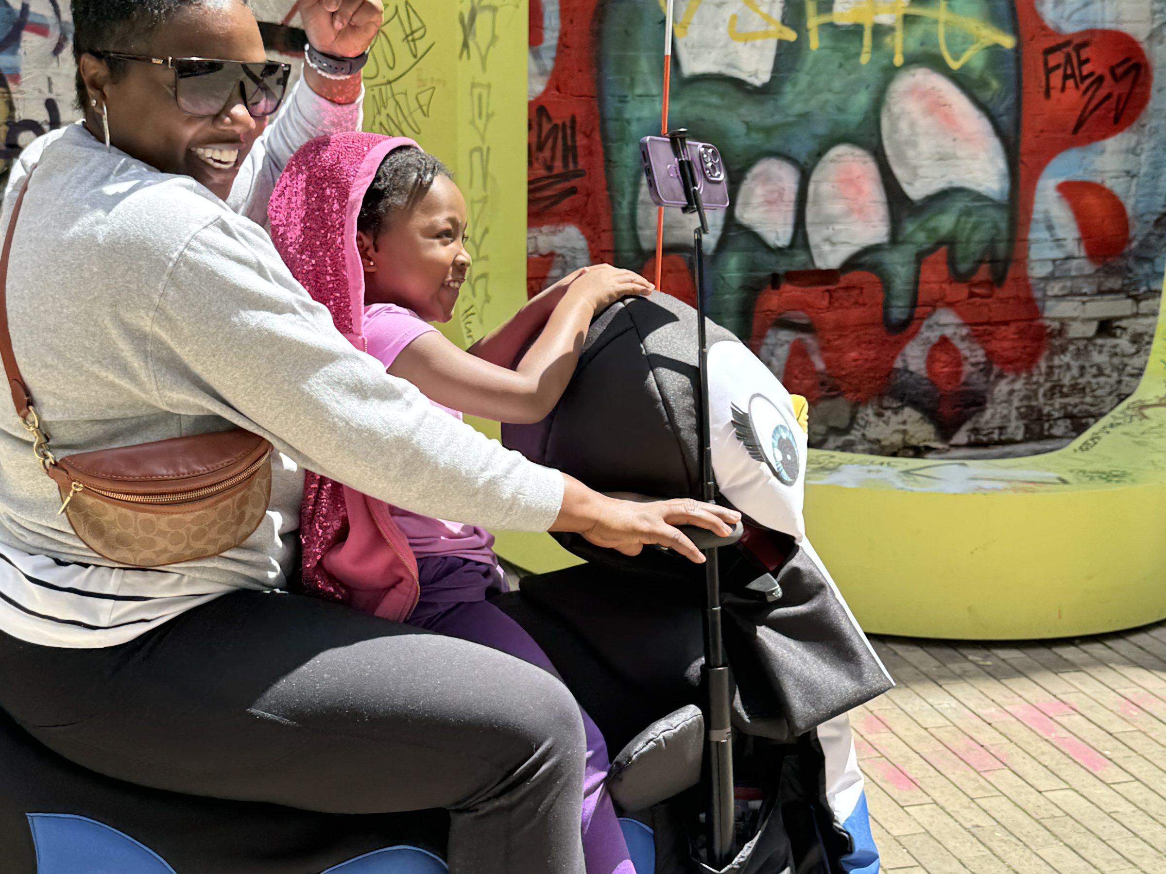 a group of people sitting in a chair talking on the phone