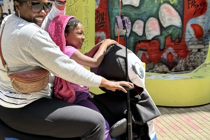 a group of people sitting in a chair talking on the phone