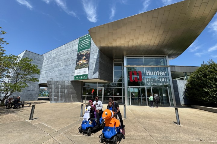 a group of people sitting in front of a building