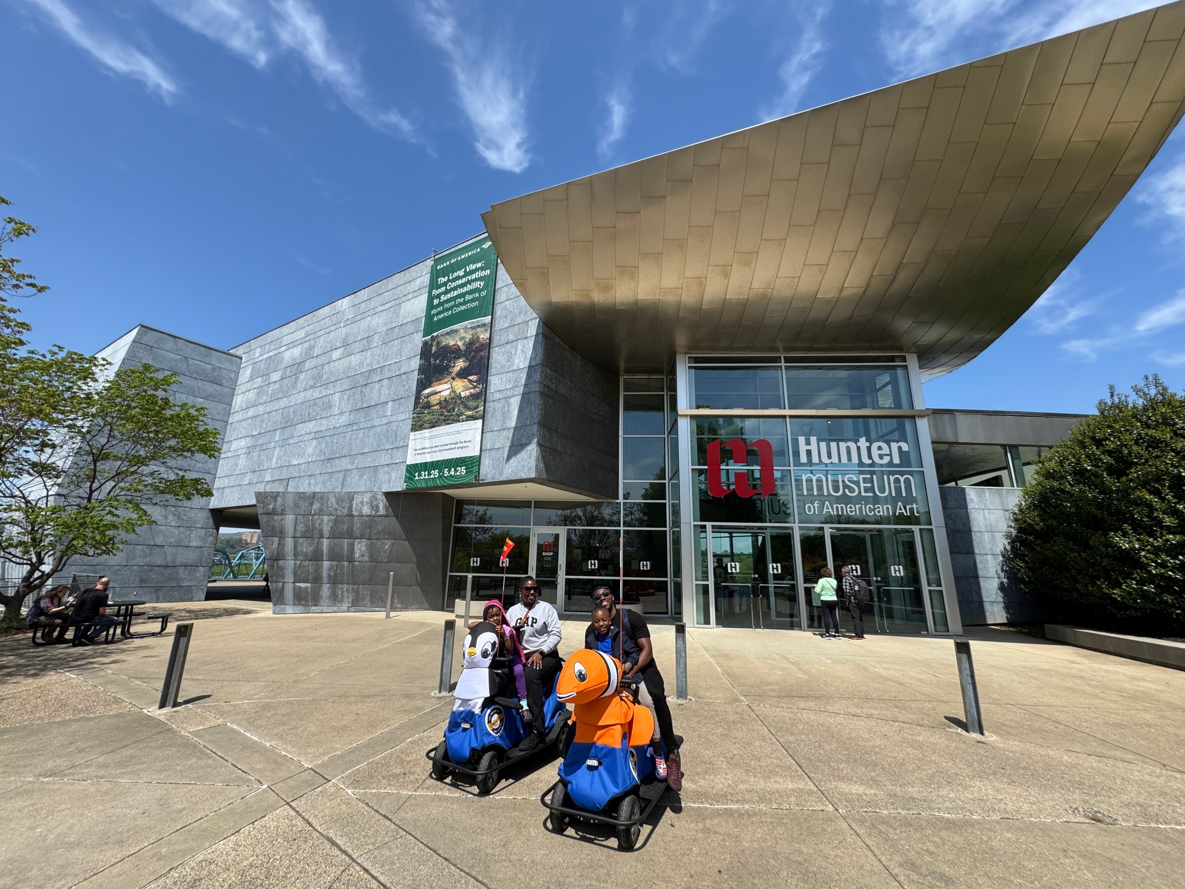 a group of people sitting in front of a building