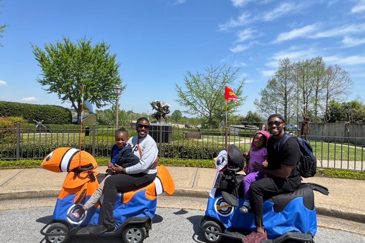 a group of people riding on the back of a motorcycle